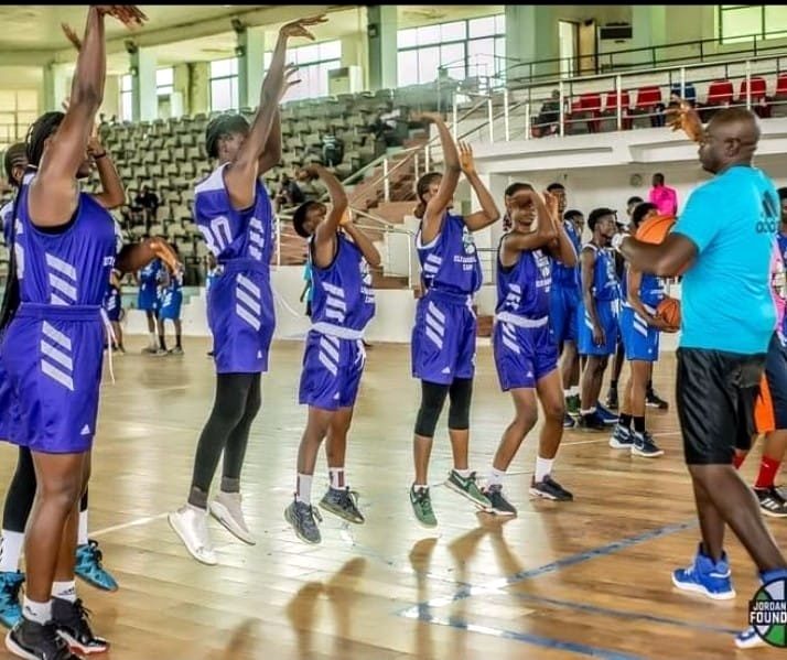 Girls practicing basketball drills during an indoor youth development clinic